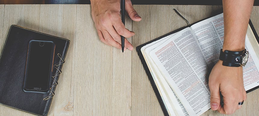 sitting-at-desk-with-bible-journal-phone